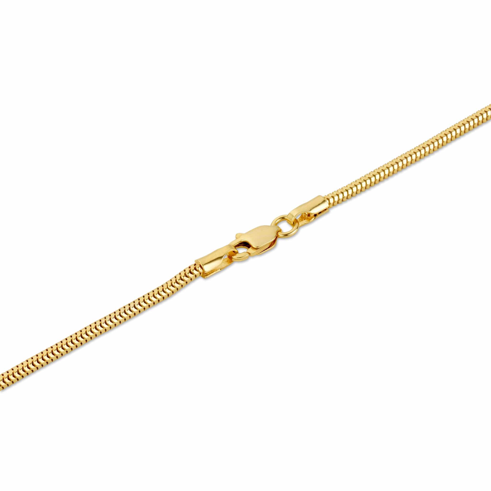 A close-up of a yellow gold snake chain necklace clasp on a white surface.