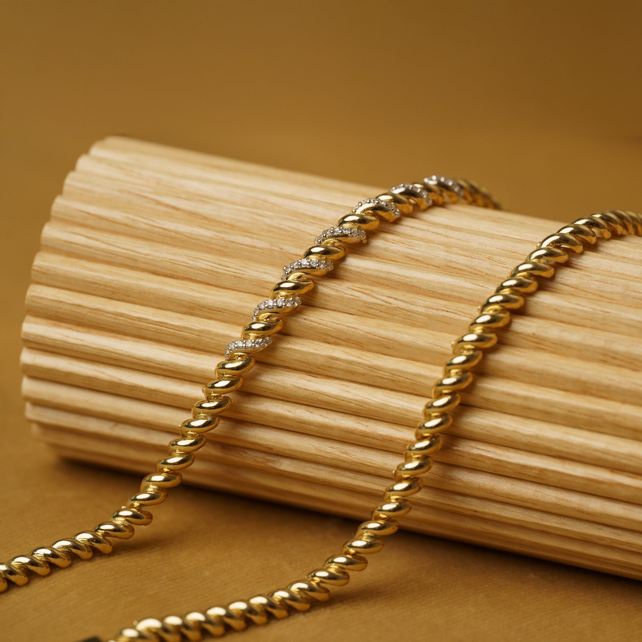 Gold andYellow Gold and Diamond Bracelets on Neutral background