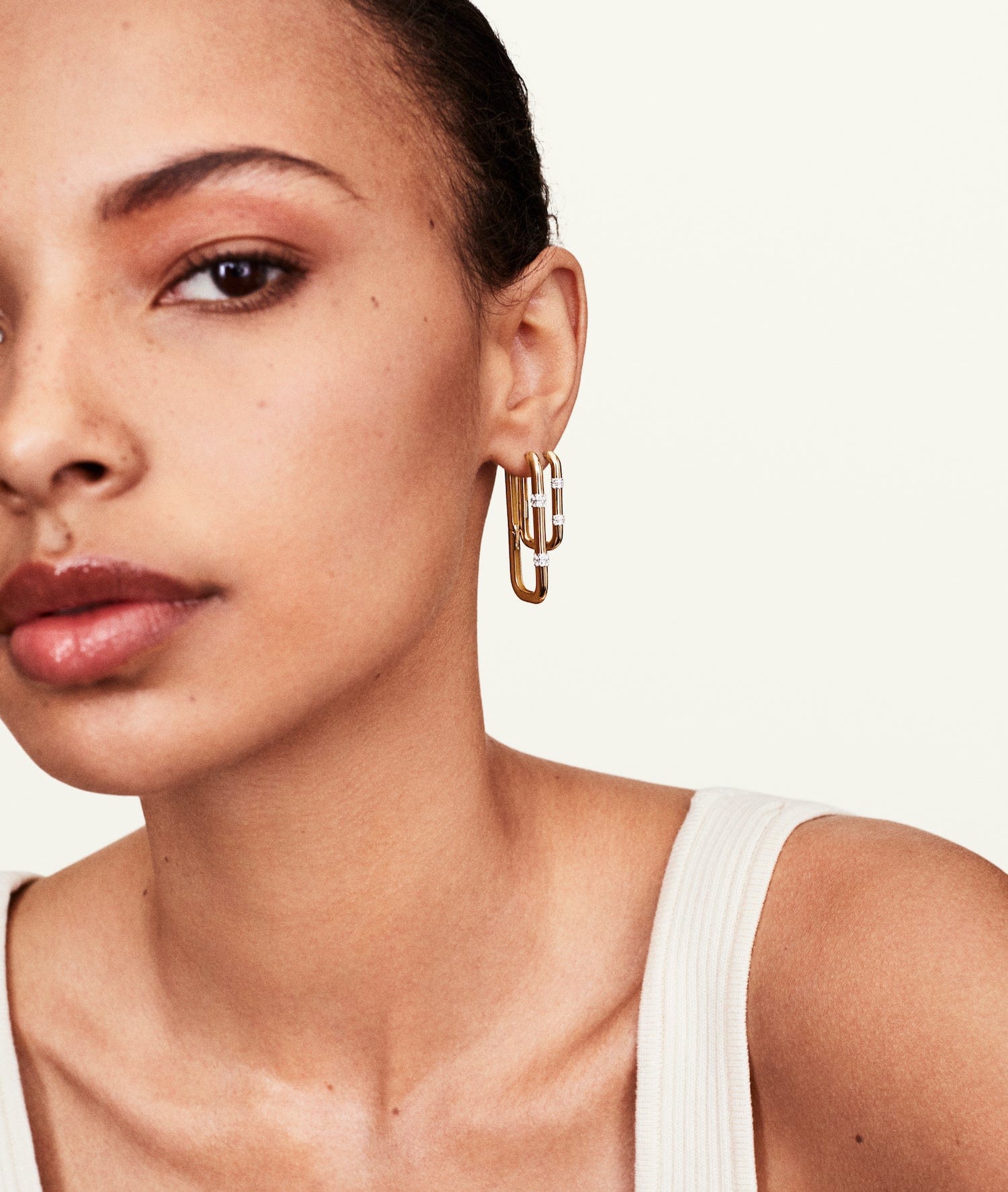 Model wearing double row diamond hoop earrings