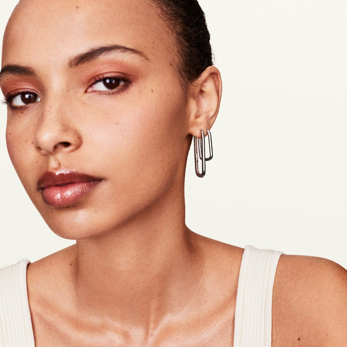 Model wearing Rumi long rectangle earrings