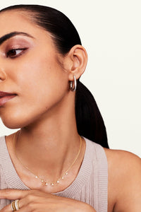Model showcasing teardrop diamond earrings