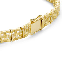 Close up shot of woven gold chain bracelet clasp