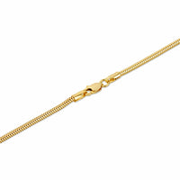 Close-up of a clasp on a gold snake chain anklet.