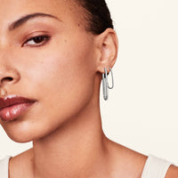 Model wearing rectangle diamond earrings