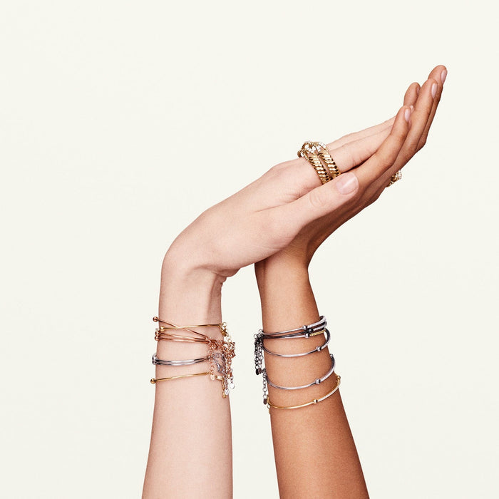 Shot of models' hands and wrists wearing the black diamond bracelet