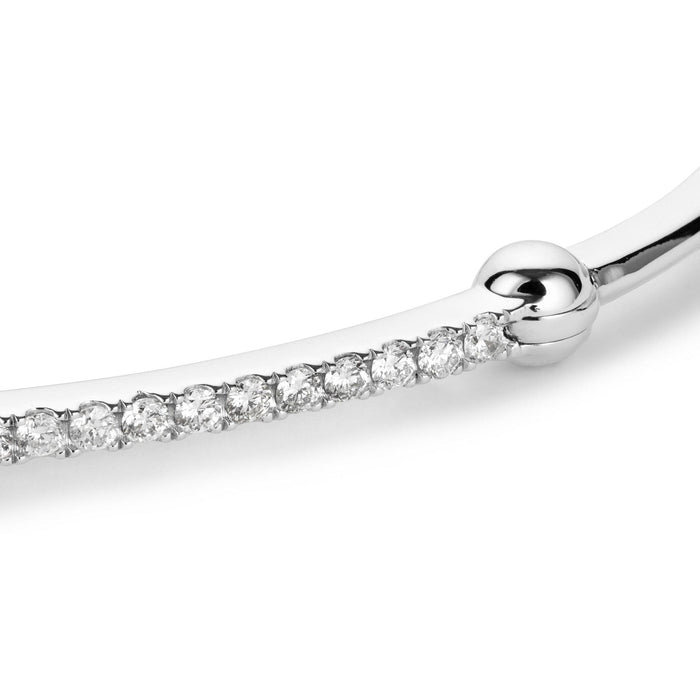Close up shot of white gold bracelet with diamond bar