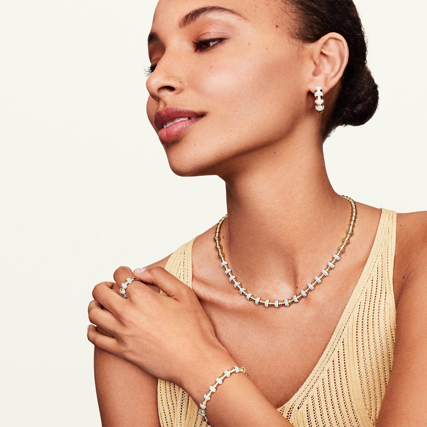 Model wearing hourglass diamond statement earrings with matching jewelry