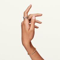 A hand displaying the 14k white gold infinity ring.