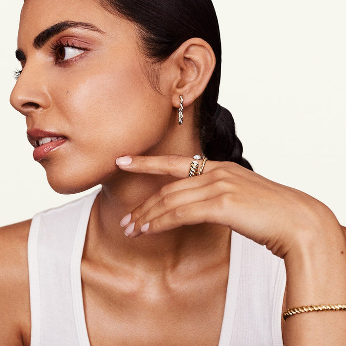 A person displaying the 14k yellow gold infinity ring on their finger.