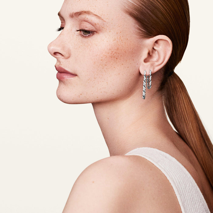 Model wearing diamond infinity hoop earrings