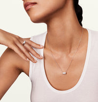 Model wearing the allumare white gold diamond cylinder ring and matching necklace