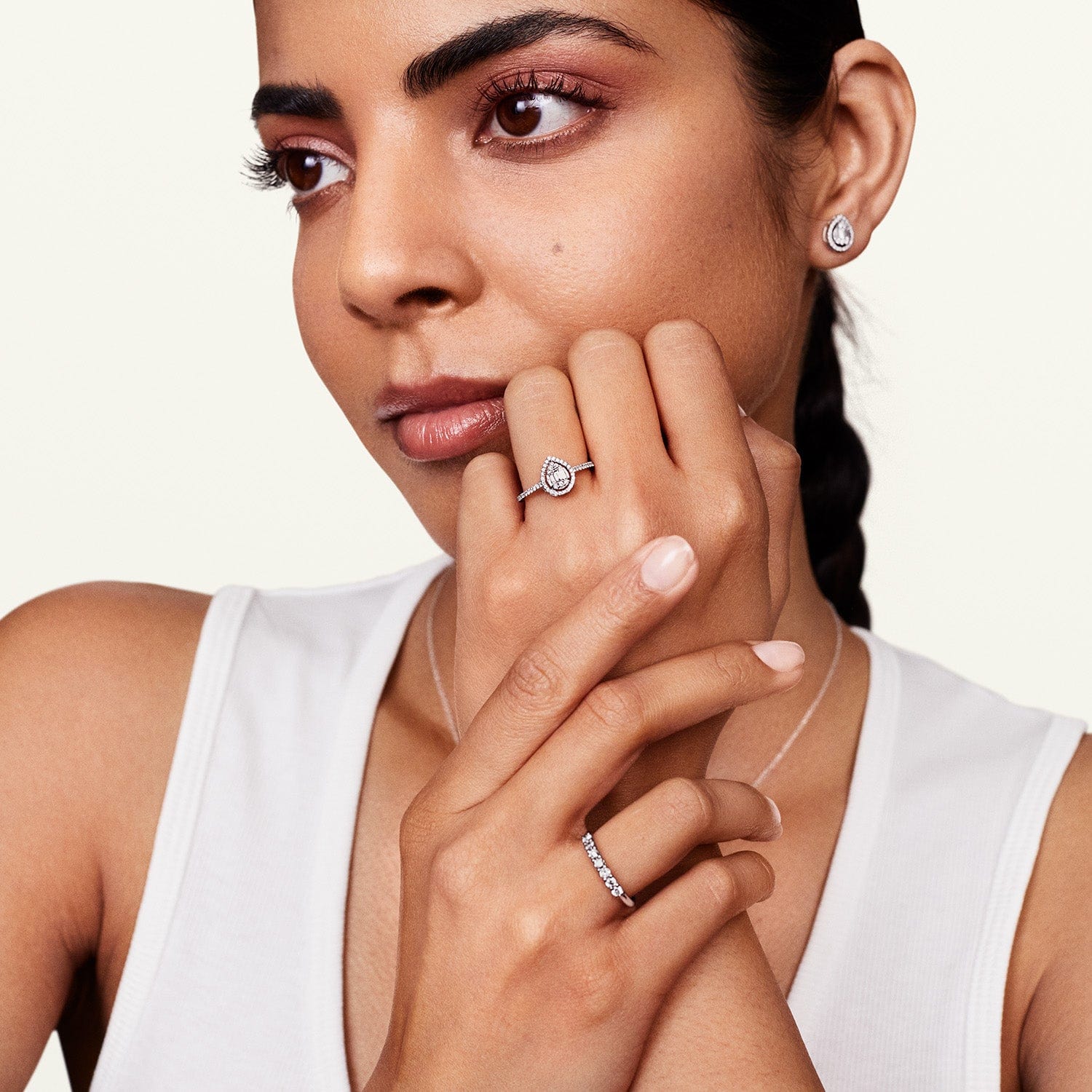 Model wearing allumare diamond halo earring studs and matching jewelry 