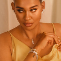 Model wearing allumare white gold 2 prong diamond pendant necklace with matching jewelry