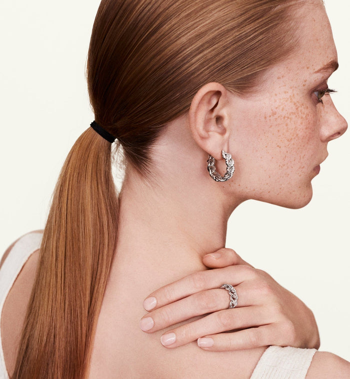 Model wearing white gold diamond braided ring 