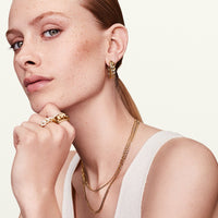 Model wearing gold chain hoop earrings 