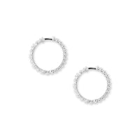 Side shot of white gold hoop earrings with diamonds