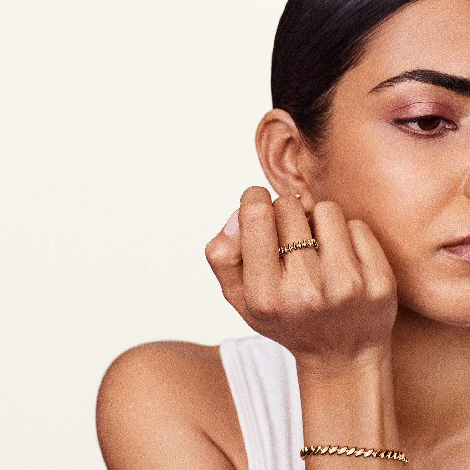 Close up show of model's wrist showcasing the leaf bracelet pattern