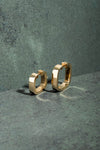  Gold square hoop earrings on a green textured background