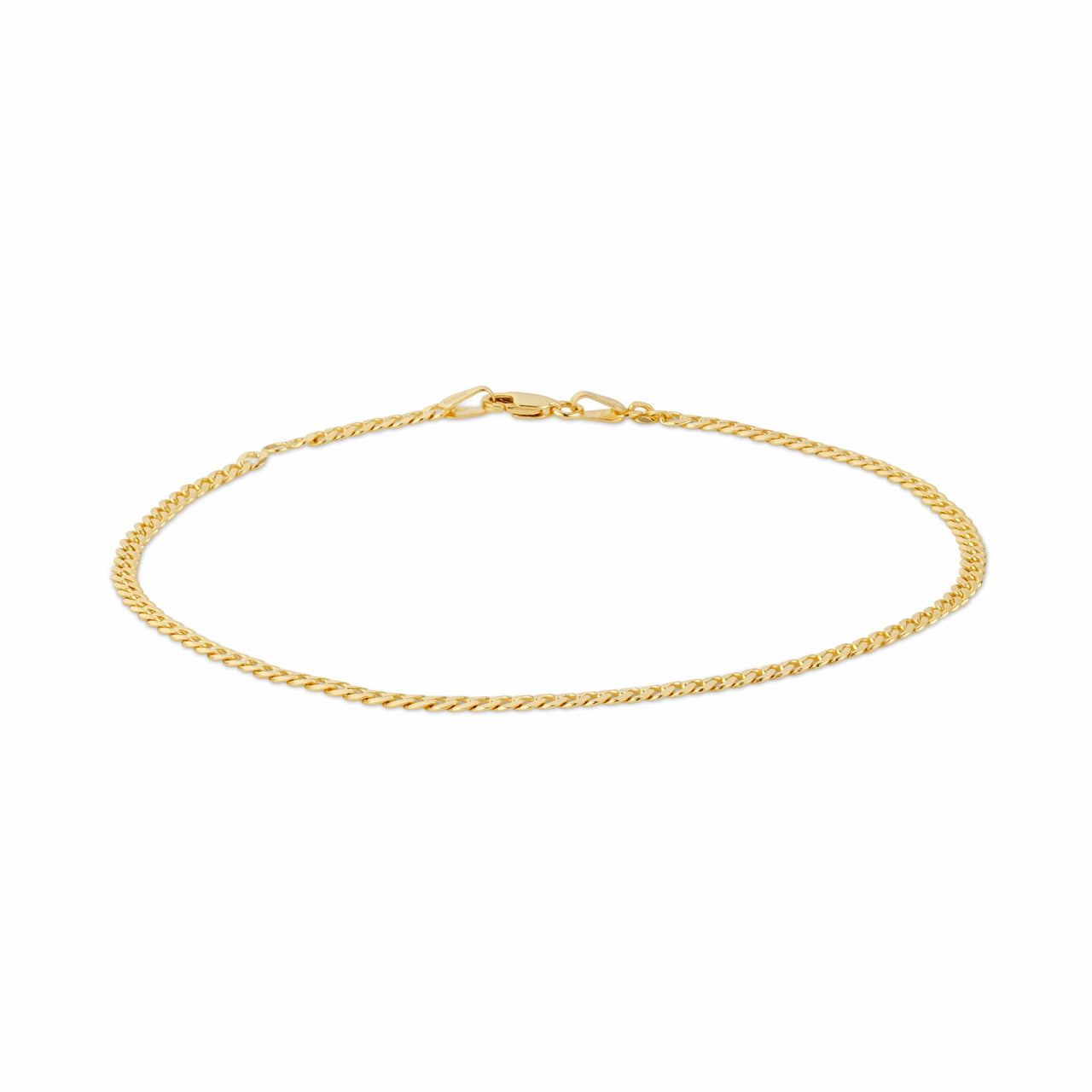 A gold curb link chain bracelet on a white backdrop.