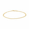 A gold curb link chain bracelet on a white backdrop.