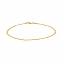 Close-up of a thin gold anklet chain with a clasp.