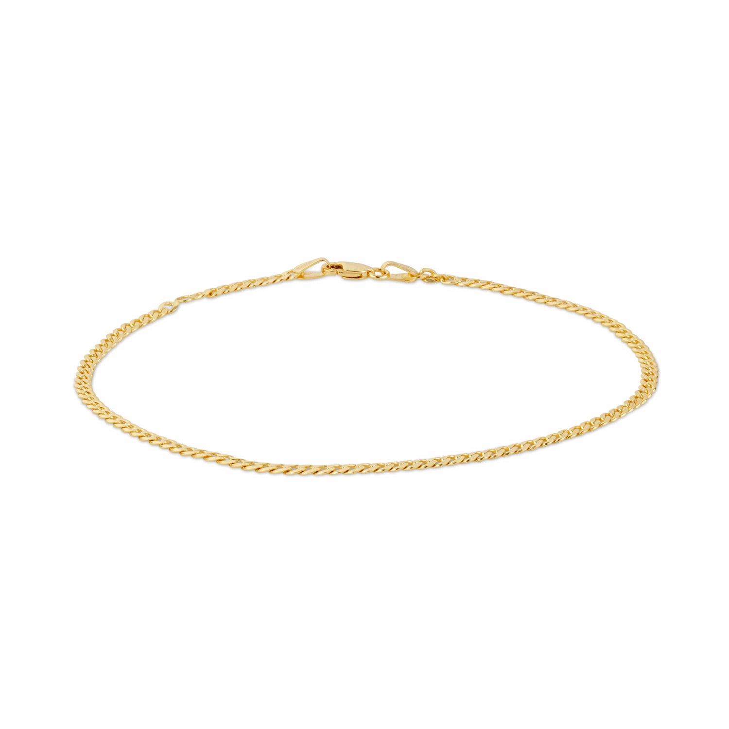 Close-up of a thin gold anklet chain with a clasp.